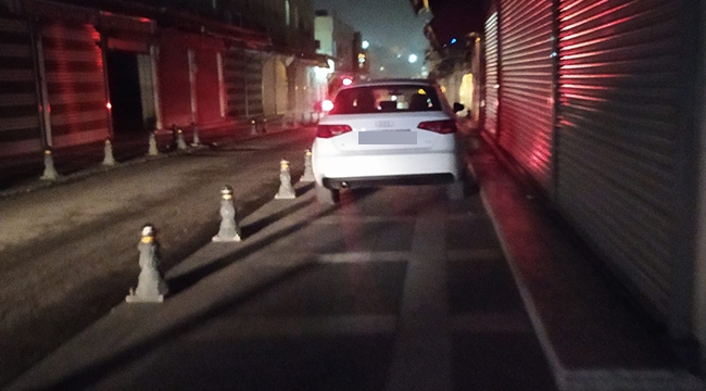 Karanlıklar içinde kalan caddede otomobilini kaldırıma park etti